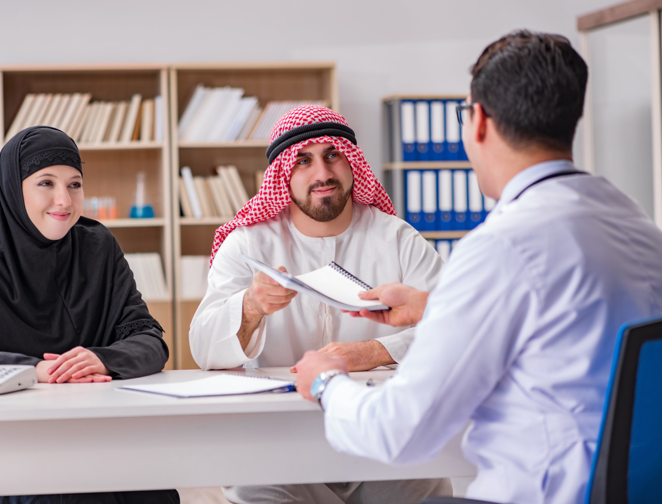 Doctor consulting arab family at hospital